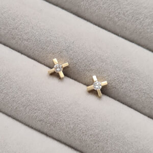 micro xx earrings in yellow gold with diamonds on a grey velvet tray.