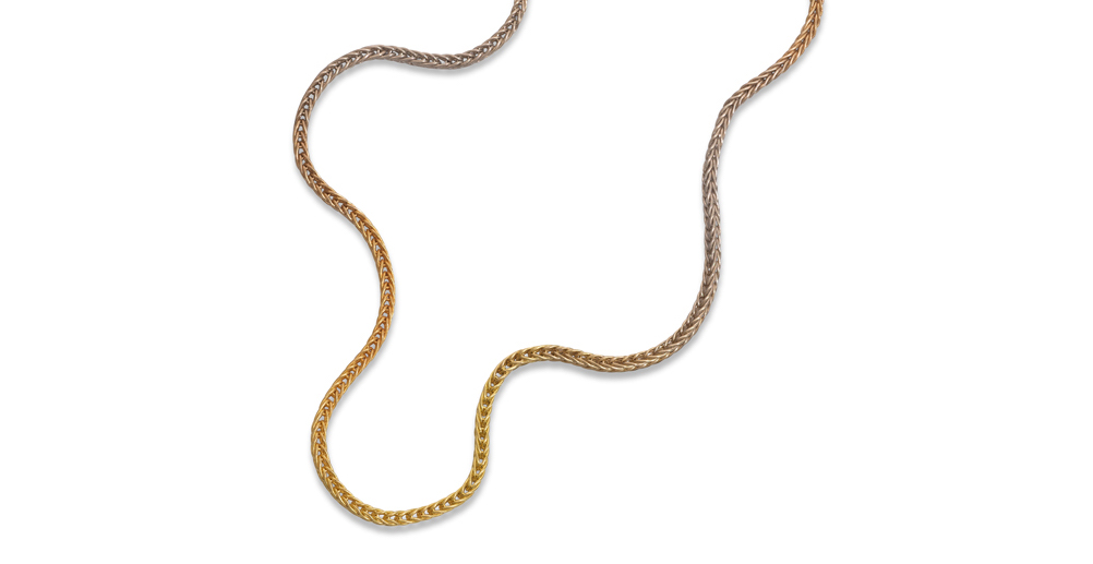 gold gradient loop in loop chain necklace on white background