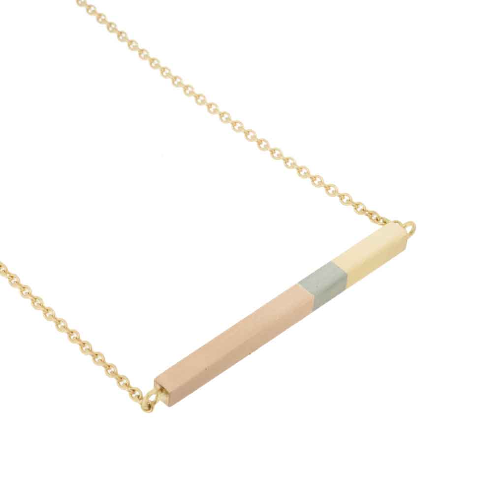 Bar necklace in rose, white and yellow gold on a white background.