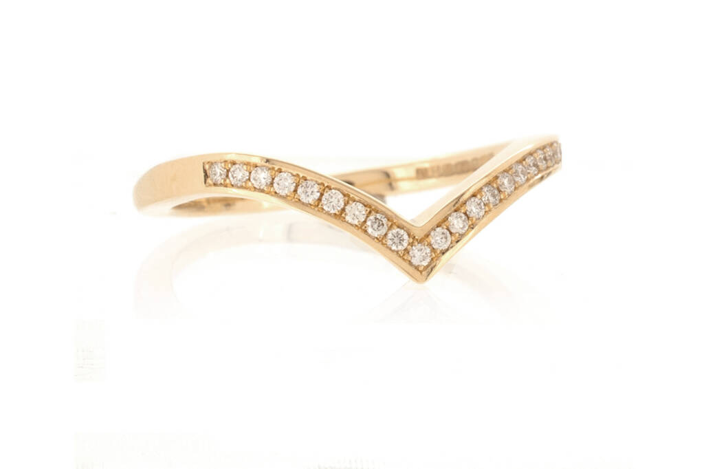 Diamond set V-shaped, wishbone wedding band in light rose gold on a white background.