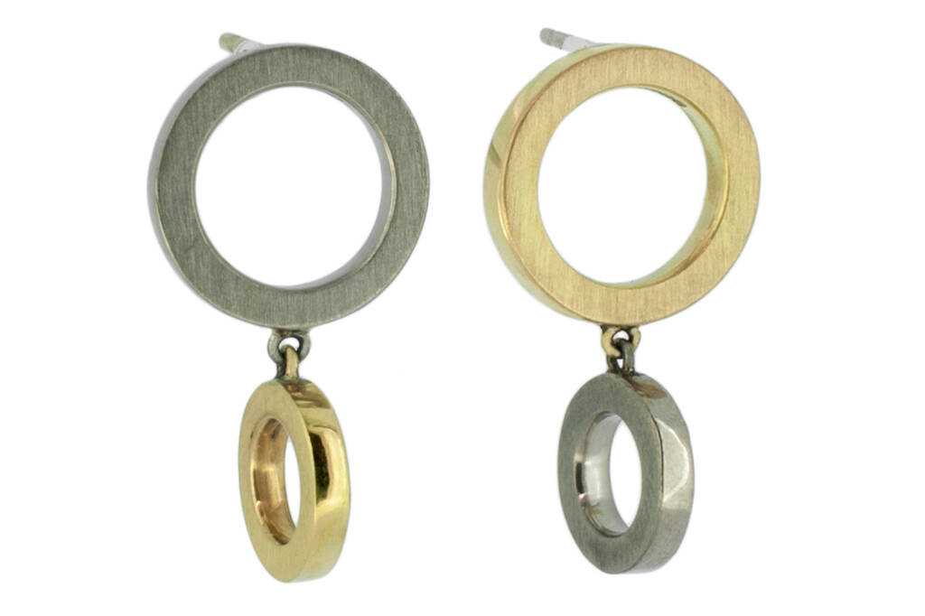 Two tone yellow and white gold earrings on a white background.