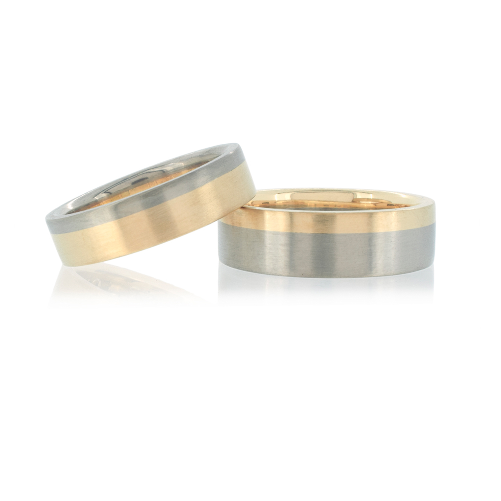 Bi-coloured wedding bands in yellow and white gold. One ring has inverse colours from the other.