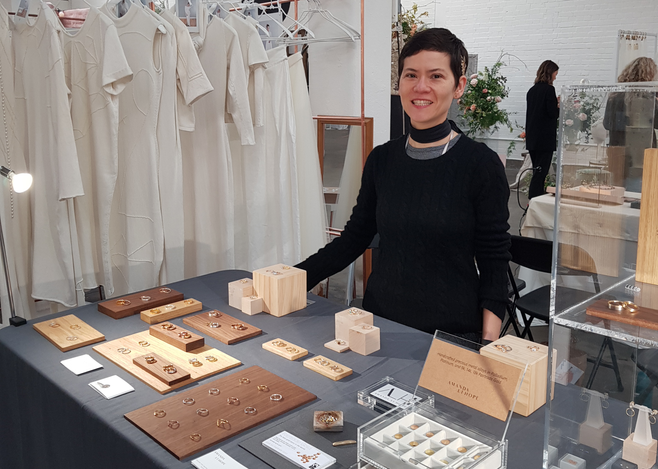 Amanda Li Hope showing her handmade bespoke weeding bands and enagement rings on a table at most curious wedding fair