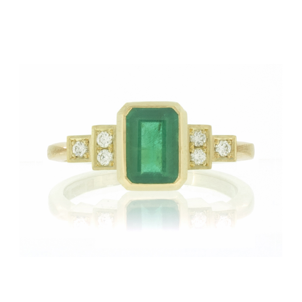 Front view of Emerald and diamond engagement ring on white background.
