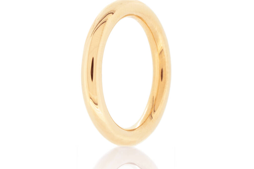 Halo ring in light rose gold standing up on a white background.