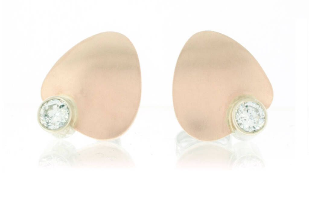 Petal shaped stud earrings in rose gold with diamonds set in contrasting white gold on white background.