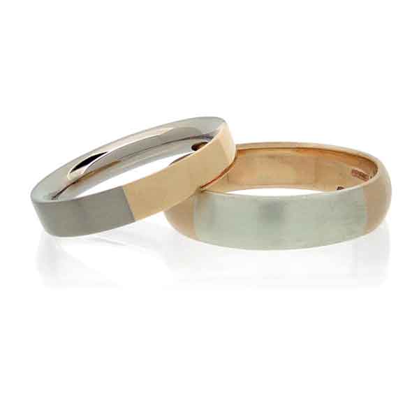 Two wedding rings in rose and white gold on a white background.