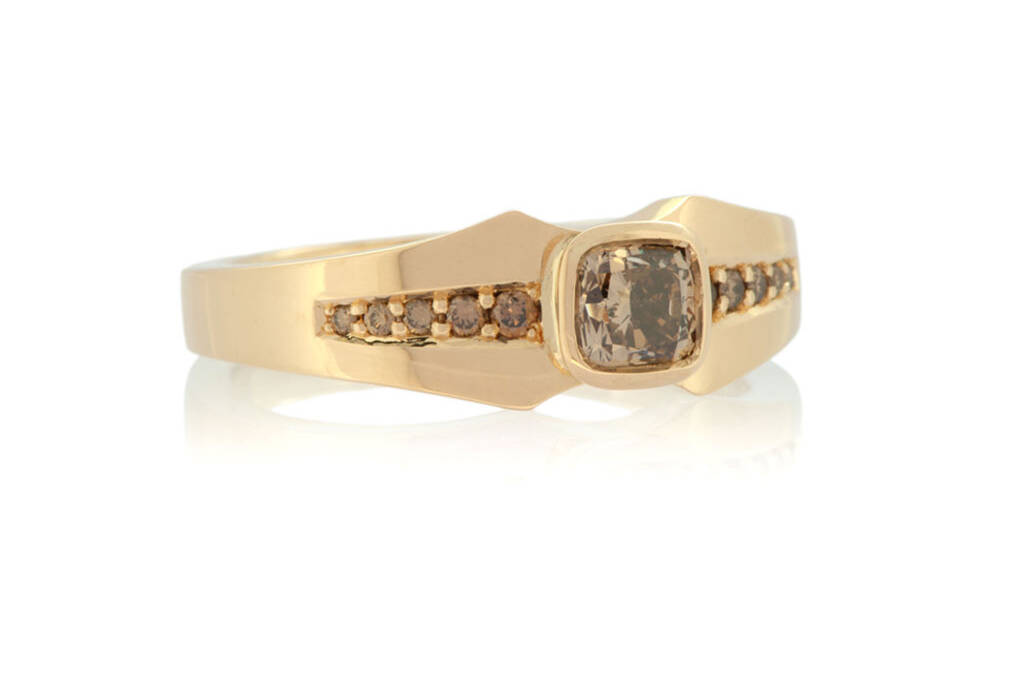 Front view of a light rose gold diamond ring with a tapering design set with a cushion cut champagne diamond and graduated champagne diamonds on a white background.