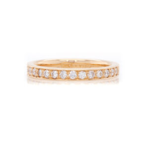 yellow gold ring with diamonds on a white background