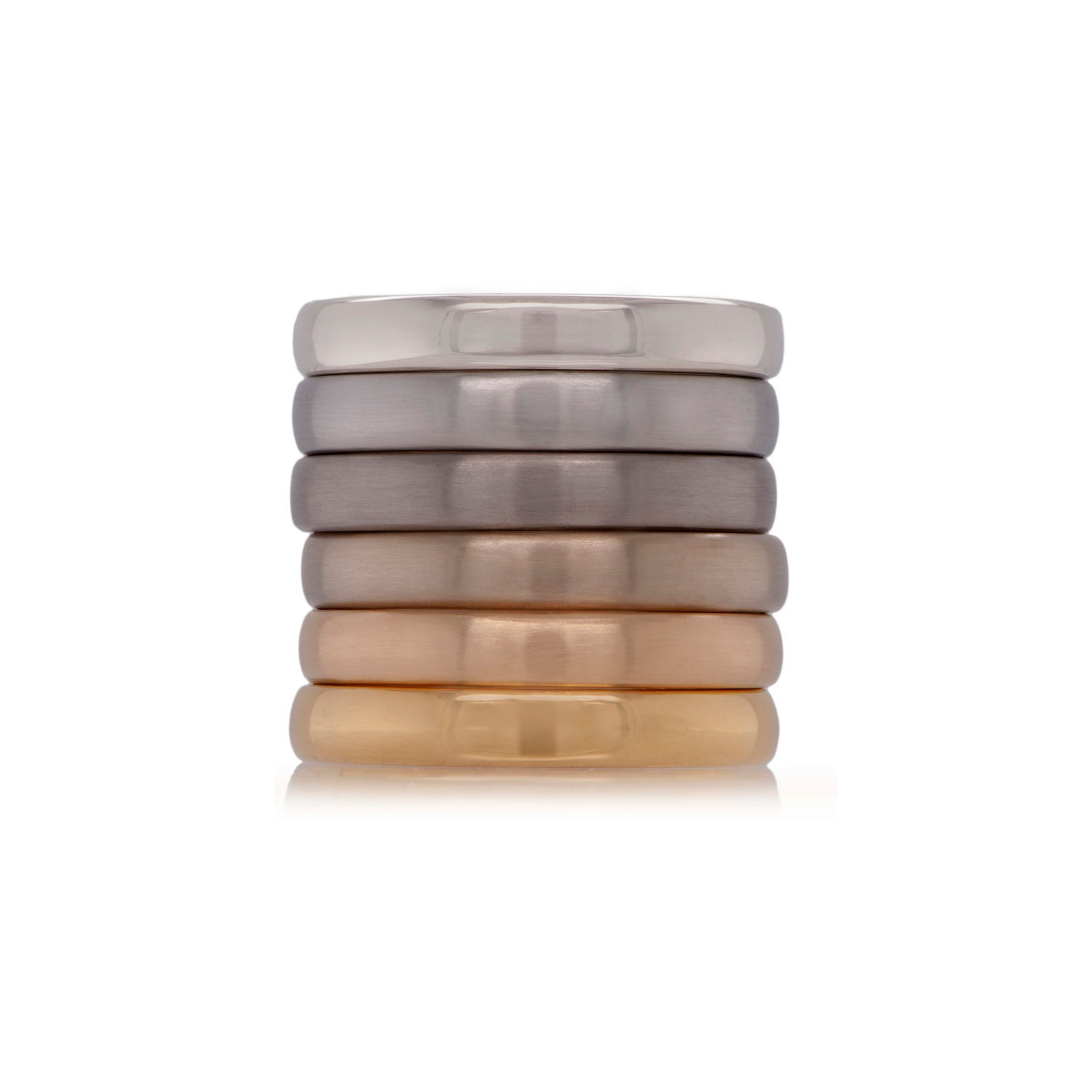 six ethical wedding rings in different tones of gold in a single stack on white background