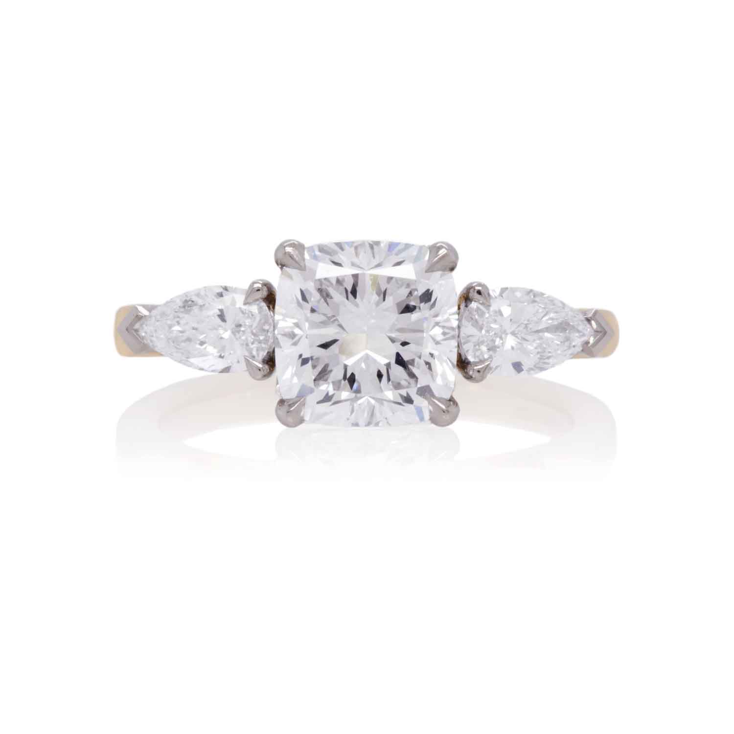 Close‑up of a cushion‑cut centre diamond with pear‑cut side stones.