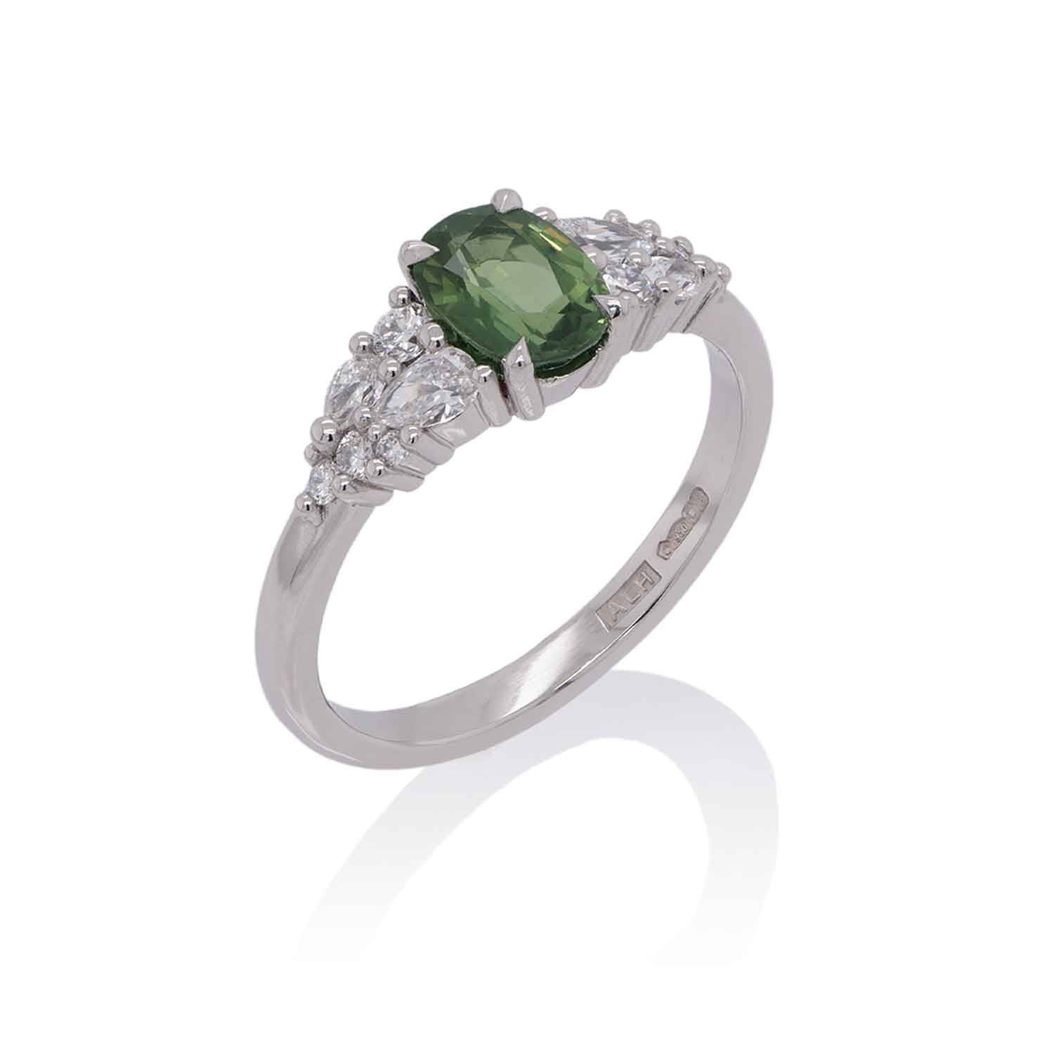 Bespoke platinum ring featuring a 1.27ct natural green sapphire, framed by pear‑cut and round lab‑grown diamonds.